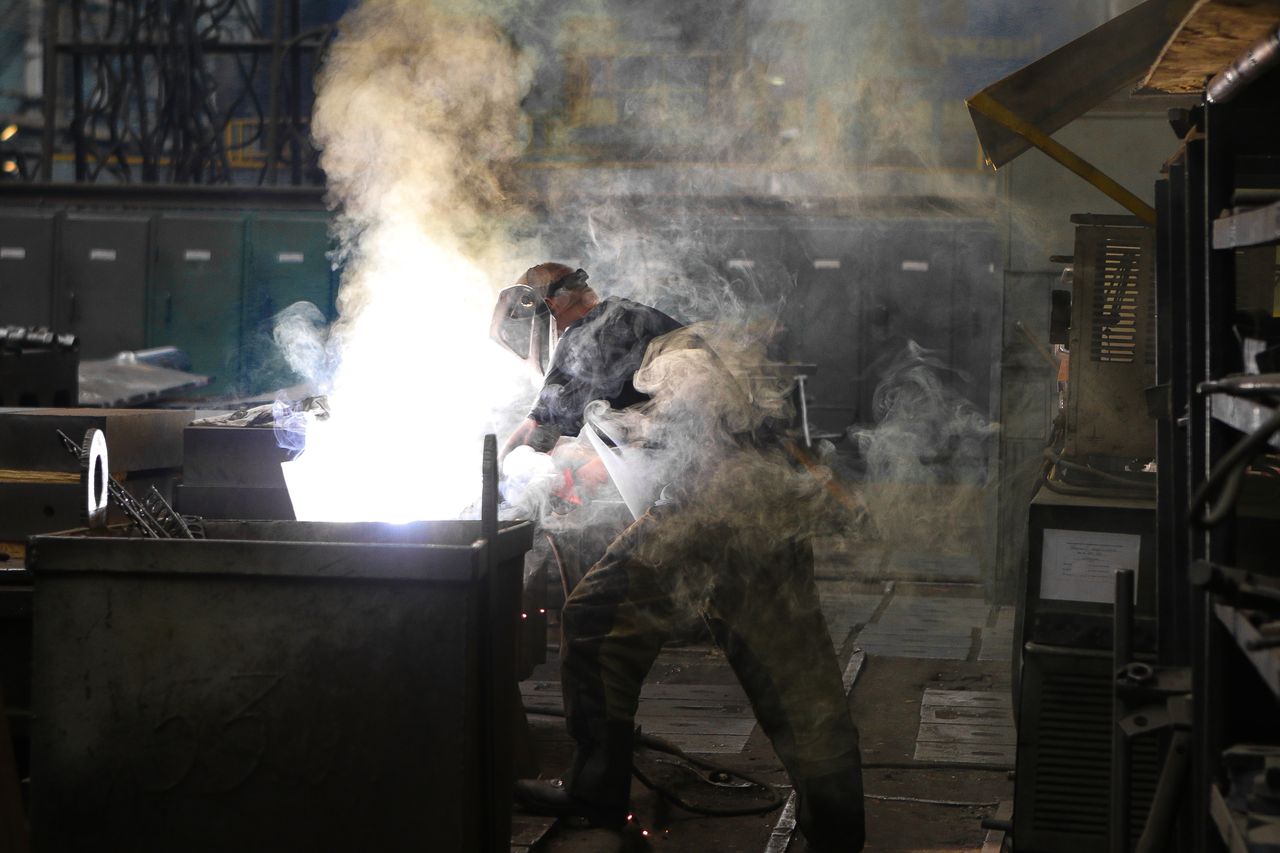 Welder at work with torch and flame